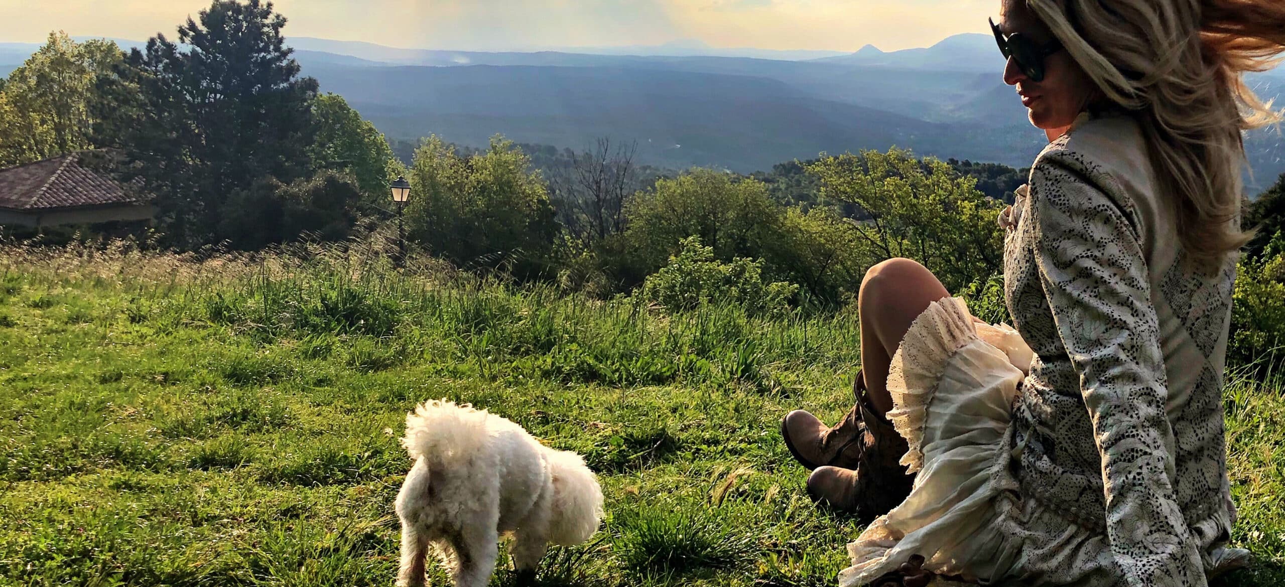 woman sitting by dog land against sky 2